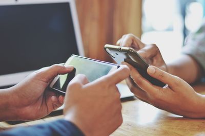 Midsection of man using mobile phone