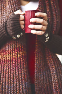 Close-up of woman holding a red mug