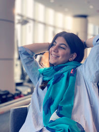 Portrait of a smiling young woman on bed