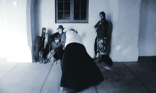 Side view of young woman lying down on window