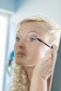 Close-up of woman applying mascara