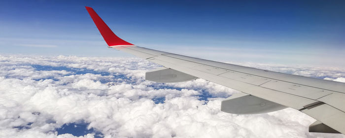 Airplane wing against sky