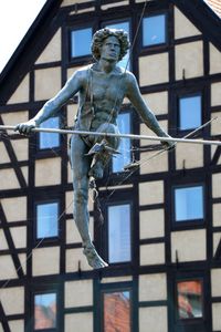 Low angle view of statue against building