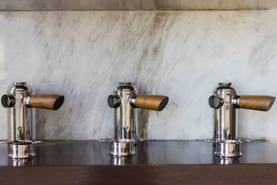 Close-up of taps against wall