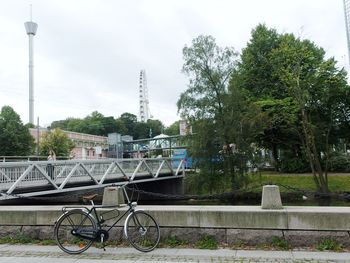 Bicycle in city against sky