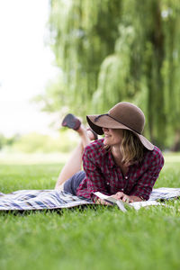 A young woman reads a book in a park in the columbia gorge.