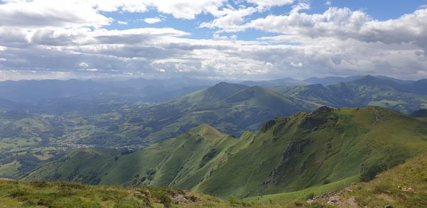 Scenic view of valley and mountains against sky