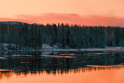 Scenic view of lake against orange sky