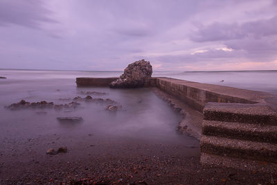 Scenic view of sea against cloudy sky