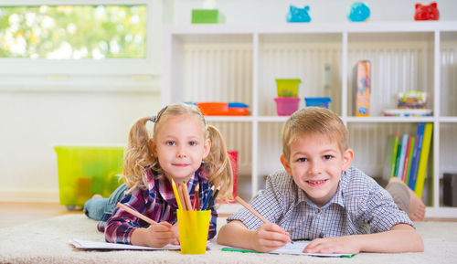 Portrait of sibling studying at home