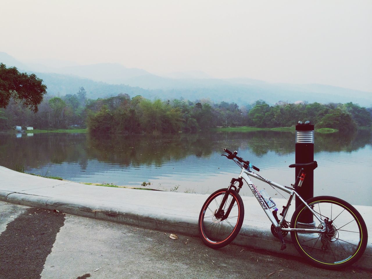 bicycle, mode of transport, transportation, land vehicle, parked, stationary, water, tree, lake, parking, mountain, tranquility, tranquil scene, clear sky, river, sky, scenics, nature, nautical vessel, beauty in nature