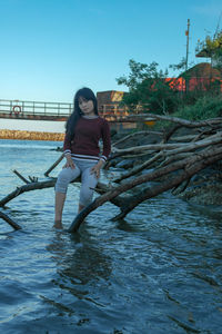 Full length of woman on water against clear sky