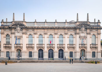 Facade of historic building against clear sky