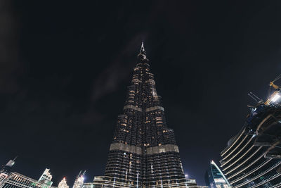 Low angle view of skyscrapers lit up at night