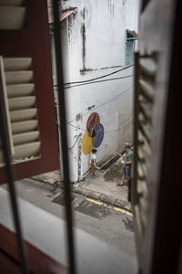 Man working on window of building