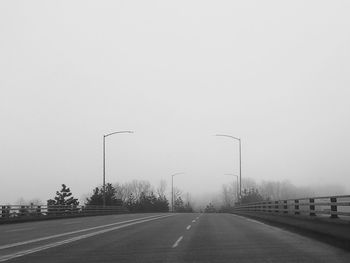 Road against clear sky during winter
