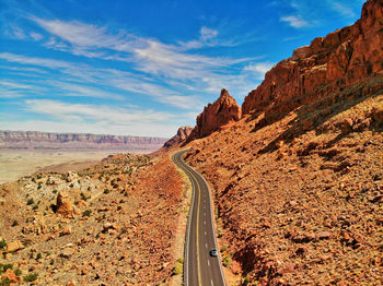 Rock formations on road against sky