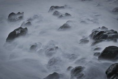 Aerial view of rocks in sea