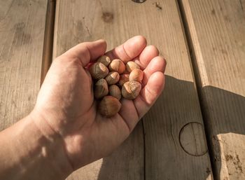 High angle view of hand holding bread on table