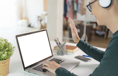 Low angle view of woman using laptop on table