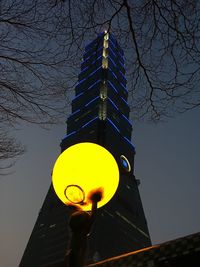 Low angle view of illuminated building against sky at night