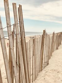 Close-up of wood on beach against sky