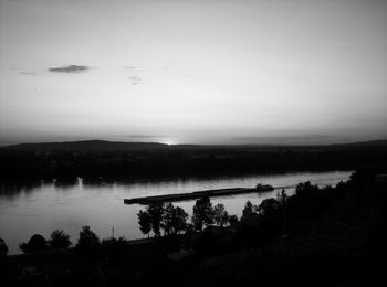 Scenic view of lake against sky at night