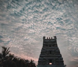Low angle view of silhouette temple against sky
