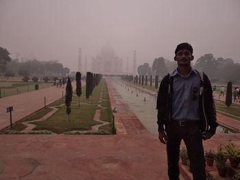 Man standing on foggy day