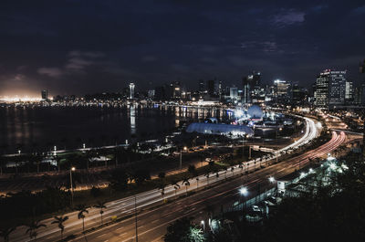 High angle view of illuminated city street and buildings at night