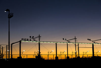 Low angle view of illuminated street light against clear sky