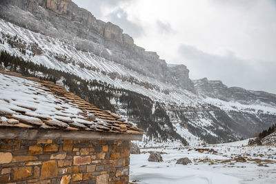 Scenic view of snow covered mountains against sky