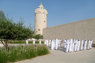 Traditional emirati male al ayalah dance at al hosn festival