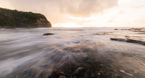 Scenic view of sea against cloudy sky