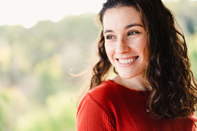 Portrait of smiling young woman standing outdoors