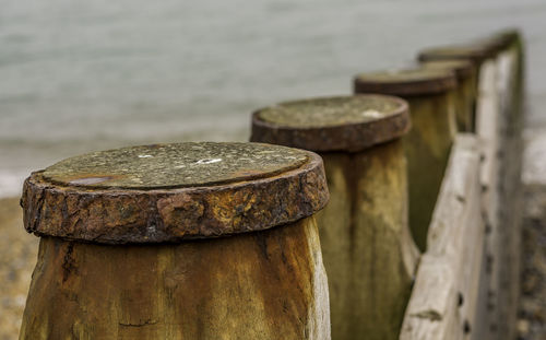 Close-up of rusty metal by sea