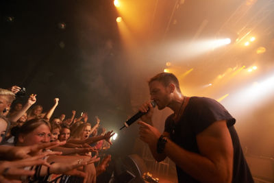 Singer with crowd in music concert