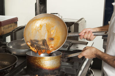 Midsection of chef preparing food in kitchen