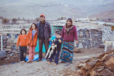 Portrait of a smiling girl standing against the wall