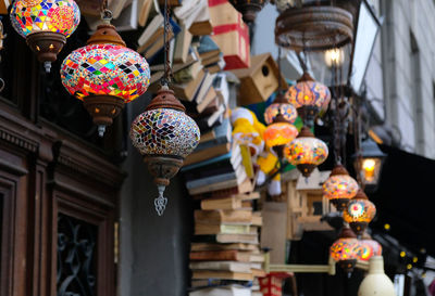 Low angle view of illuminated lanterns hanging in store