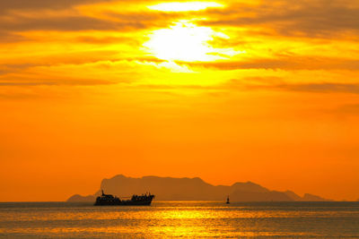 Scenic view of sea against orange sky