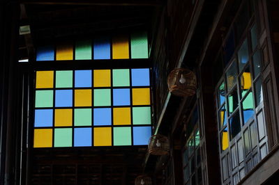 Low angle view of multi colored glass window of building