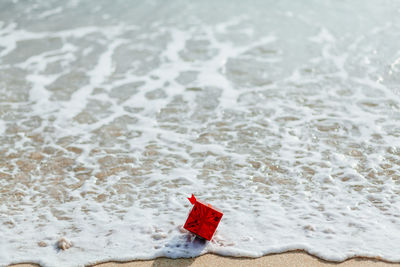 High angle view of christmas present on shore at beach