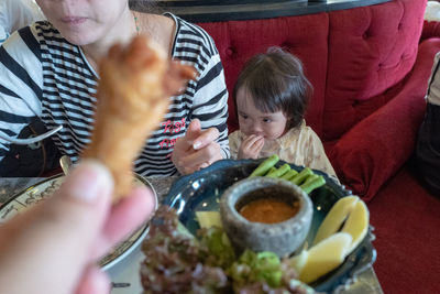 Rear view of people eating food
