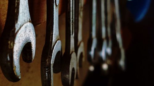 Close-up of rusty metal hanging on wood