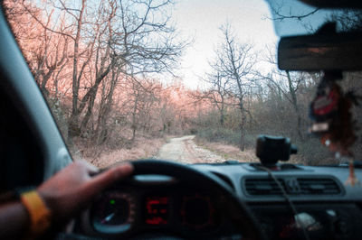 Person seen through car windshield