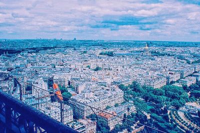View of cityscape against cloudy sky