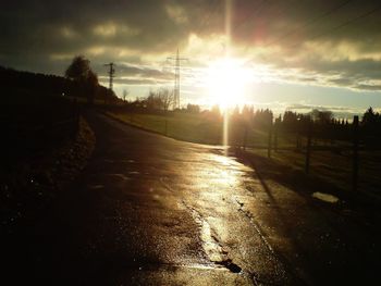 Road amidst landscape against sky during sunset