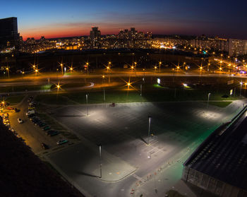 High angle view of illuminated cityscape against sky at night