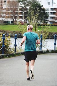Rear view of man running in city